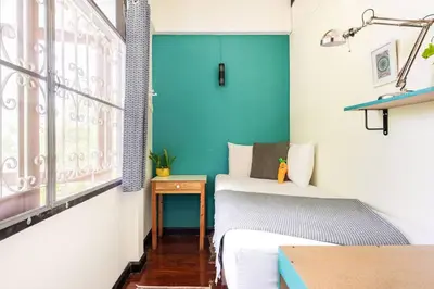 a small room with a bed and a window at Bang Chak Homestay in Amphoe Phra Khanong