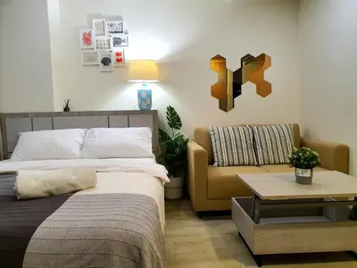 a bedroom with a bed and a couch at I'M Chinatown Residence Yaowaraj Bangkok Watmungkorn MRT Station in Bangkok