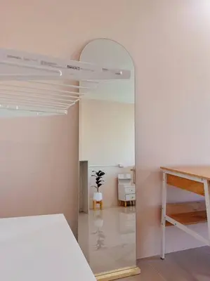 a bedroom with a mirror and a bed and a table at 29th floor Studio, Cozy Workplace, Long stay, wide space in Amphoe Phra Khanong