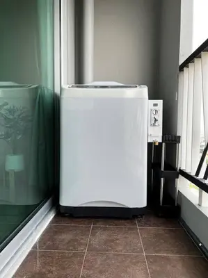 a white refrigerator in a room next to a window at 29th floor Studio, Cozy Workplace, Long stay, wide space in Amphoe Phra Khanong