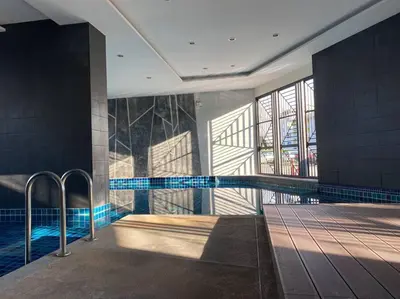 a swimming pool in a building with a swimming pool at 29th floor Studio, Cozy Workplace, Long stay, wide space in Amphoe Phra Khanong