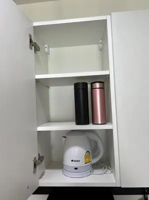 a white cabinet with a blender and a coffee mug at 29th floor Studio, Cozy Workplace, Long stay, wide space in Amphoe Phra Khanong