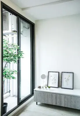 a living room with a bench in front of a window at I'm Chinatown Residence in Bangkok