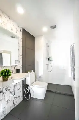 a bathroom with a toilet and a sink and a shower at I'm Chinatown Residence in Bangkok