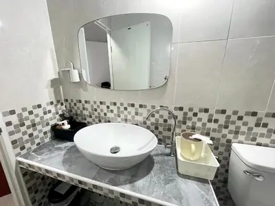 a bathroom with a sink and a mirror on a counter at Lively Impact C3-C9 in Nonthaburi