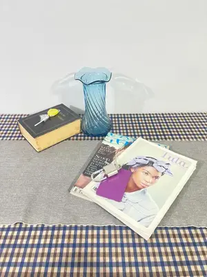 a magazine sitting on a table with a vase at Lively Impact C3-C9 in Nonthaburi