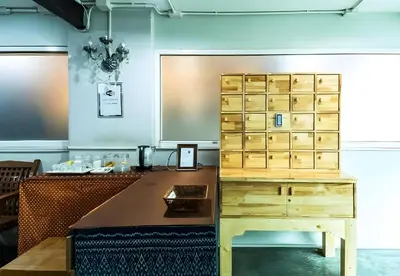 an office with a desk and a wooden cabinet at xx GO INN Khaosan Road - โก อินน์ ตรอกข้าวสาร in Bangkok