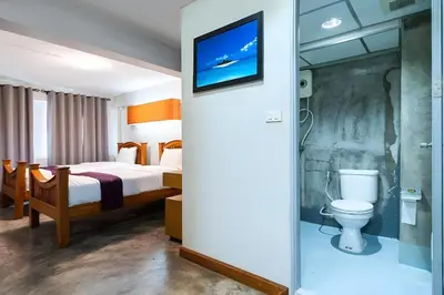 a hotel room with a bed and a toilet at xx GO INN Khaosan Road - โก อินน์ ตรอกข้าวสาร in Bangkok