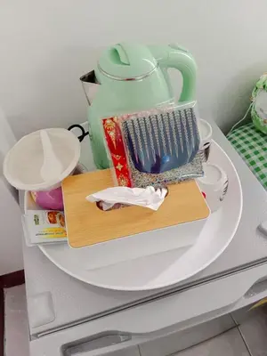 a white shelf with a tea pot on it at Worakarn Apartment 2 in Bangkok