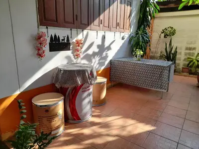a patio with two trash cans and a vase at Worakarn Apartment 2 in Bangkok