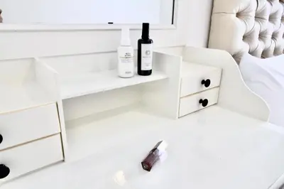 a bedroom with white furniture and a bed with two bottles of wine at Town Sukhumvit 71 in Bangkok