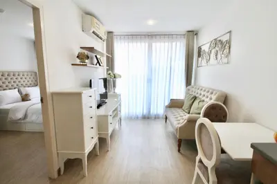 a small living room with a desk and a bed at Town Sukhumvit 71 in Bangkok