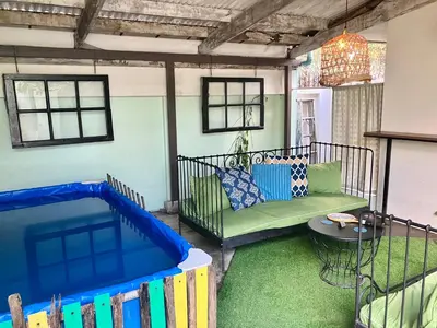 a patio with a pool and a couch and a table at OnNut Pool Homestay in Amphoe Phra Khanong