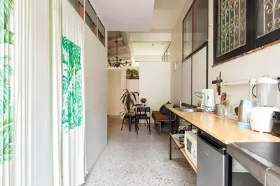 a kitchen with a counter and chairs in a room at OnNut Pool Homestay in Amphoe Phra Khanong