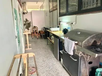 a kitchen with a counter and a stove in it at OnNut Pool Homestay in Amphoe Phra Khanong