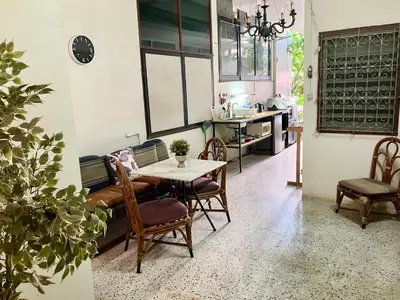 a dining room and kitchen with a table and chairs at OnNut Pool Homestay in Amphoe Phra Khanong