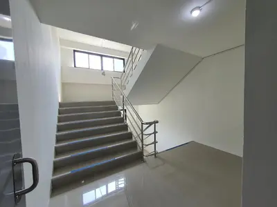 a staircase in a building with a window at Siam Rama9 Hotel in Amphoe Phra Khanong