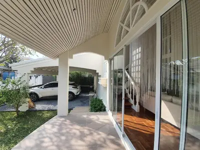 a house with a car parked in a driveway at InJoy Snow Hotel in Ban Chuat Plai Mai