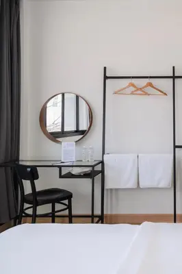 a bedroom with a desk and a mirror and a bed at CASA BLANCA Dusit in Dusit