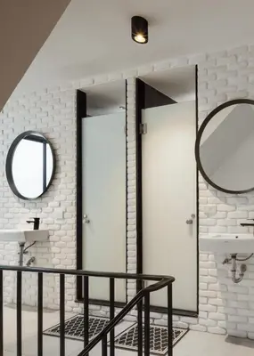 a bathroom with two white doors and a mirror at CASA BLANCA Dusit in Dusit