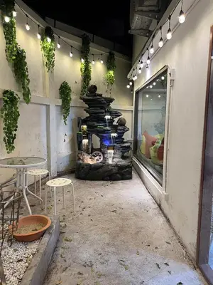 a patio with a table and chairs and lights at 77 Old Town in Bangkok