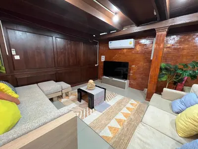 a living room with a couch and a fireplace at 77 Old Town in Bangkok