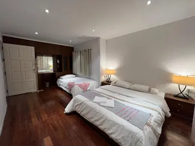 a hotel room with two beds and two lamps at 77 Old Town in Bangkok