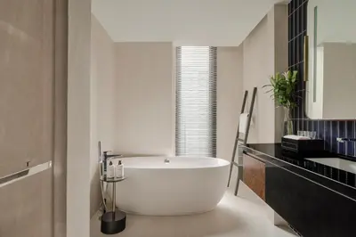 a bathroom with a white tub in a room at InterContinental Bangkok Sukhumvit by IHG in Bangkok