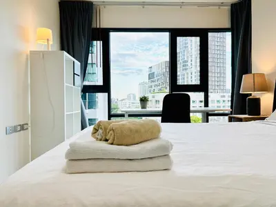 a bedroom with a bed with a towel on it at Rhythm sukhumvit 36 two bedrooms in Bangkok