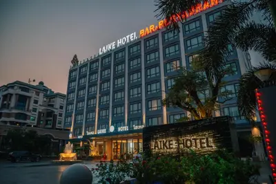 a large hotel building with a fountain in front of it at Laike Hotel in Bangkok