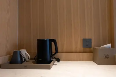a coffee pot and jug sitting on a box at Laike Hotel in Bangkok