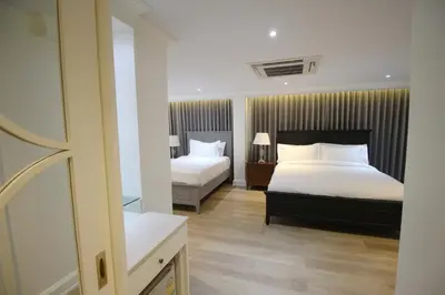 a hotel room with two beds and a mirror at SASHA HOUSE in Ban Yang