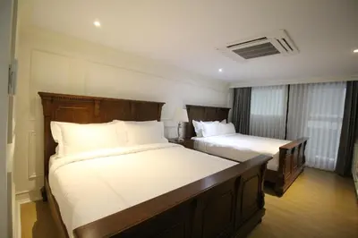 a hotel room with two beds with white sheets at SASHA HOUSE in Ban Yang