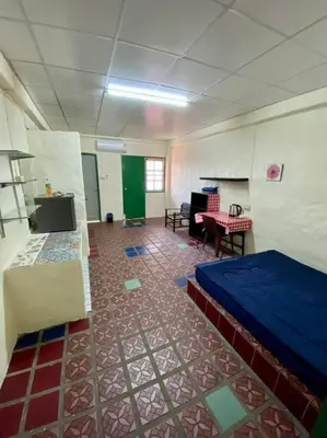 a room with a bed and a table in it at Ratanawong Place 403 in Bangkok