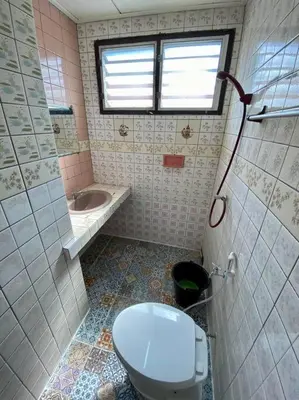 a bathroom with a toilet and a sink and a window at Ratanawong Place 301 in Bangkok