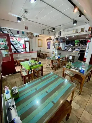a restaurant with a table and tables and chairs at Ratanawong Place 301 in Bangkok
