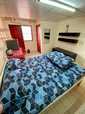 a bedroom with a large blue and white bed at Ratanawong Place 556 in Bangkok