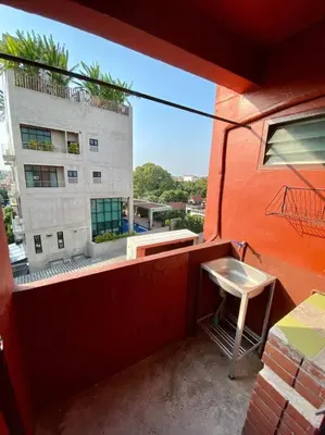 a chair sitting on the balcony of a building at Ratanawong Place 556 in Bangkok