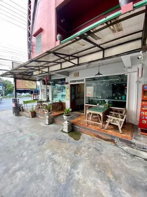 a store front with a ping pong table on the patio at Ratanawong Place 804 in Bangkok