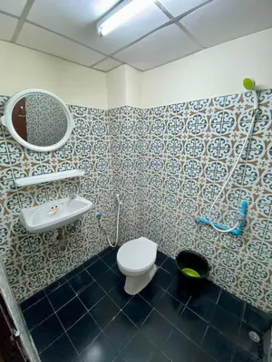 a bathroom with a toilet and a sink and a mirror at Ratanawong Place 804 in Bangkok