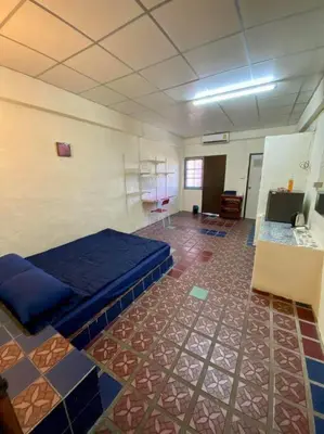 a room with a bed and a tile floor at Ratanawong Place 406 in Bangkok