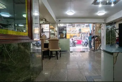 a view of a restaurant with a person standing in the doorway at IRAQI HOTEL in Makkasan