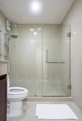 a bathroom with a glass shower with a toilet at IRAQI HOTEL in Makkasan