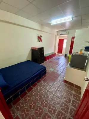 a room with a bed and a tv in it at Ratanawong Place 304 in Bangkok