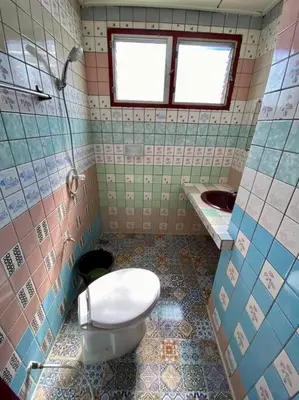 a bathroom with a toilet and a sink at Ratanawong Place 304 in Bangkok
