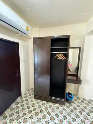 a room with an empty refrigerator in a room at Ratanawong Place 823 in Bangkok