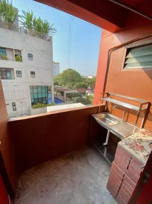 a balcony of a building with a bench and a window at Ratanawong Place 557 in Bangkok