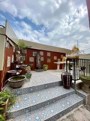 a building with a courtyard with vases on it at Ratanawong Place 557 in Bangkok