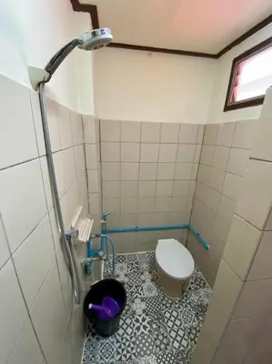 a small bathroom with a toilet and a shower at Ratanawong Place 560 in Bangkok