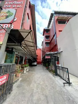 an empty street in a city with buildings at Ratanawong Place 445 in Bangkok